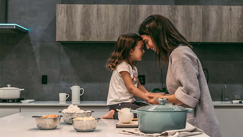 mother and daughter connecting in the kitchen